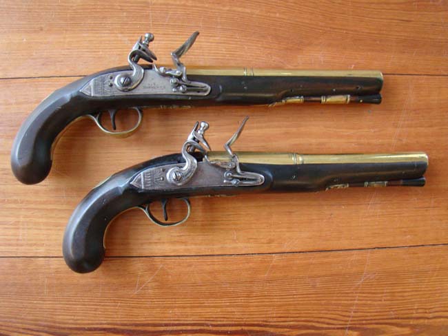 A pair of English flintlock brass barreled coaching pistols by John Bennett circa 1790